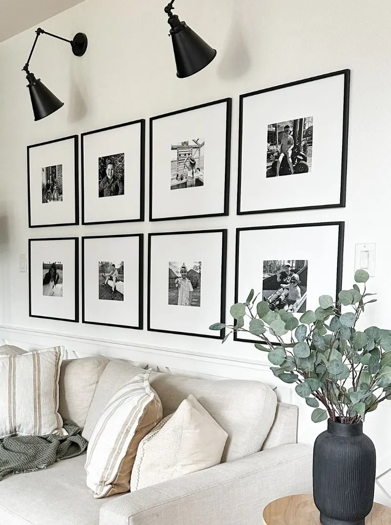 Eight black Mixtiles frames in two sizes, holding black-and-white family photos